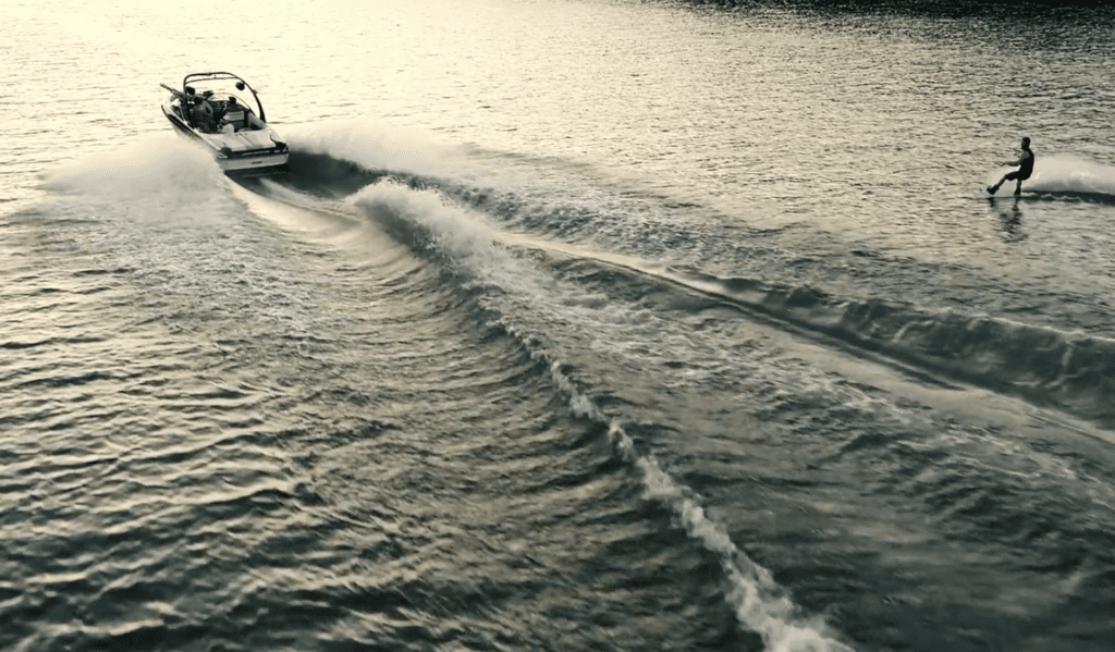 Aerial shot of someone boat skiing. 